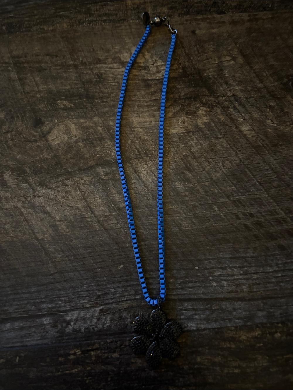 Blue enamel necklace with pave gunmetal flower charm